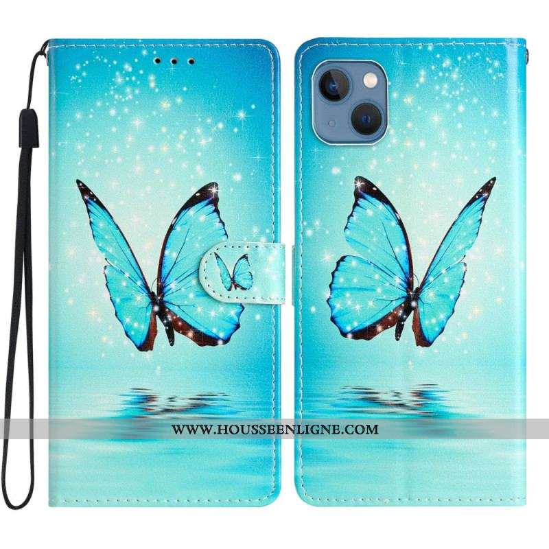 Housse iPhone 15 Papillon Bleu en Vol à Lanière